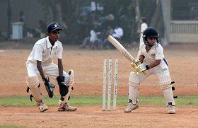 2 men playing a game of cricket