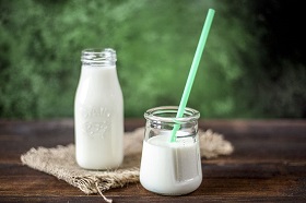 a bottle and glass of milk