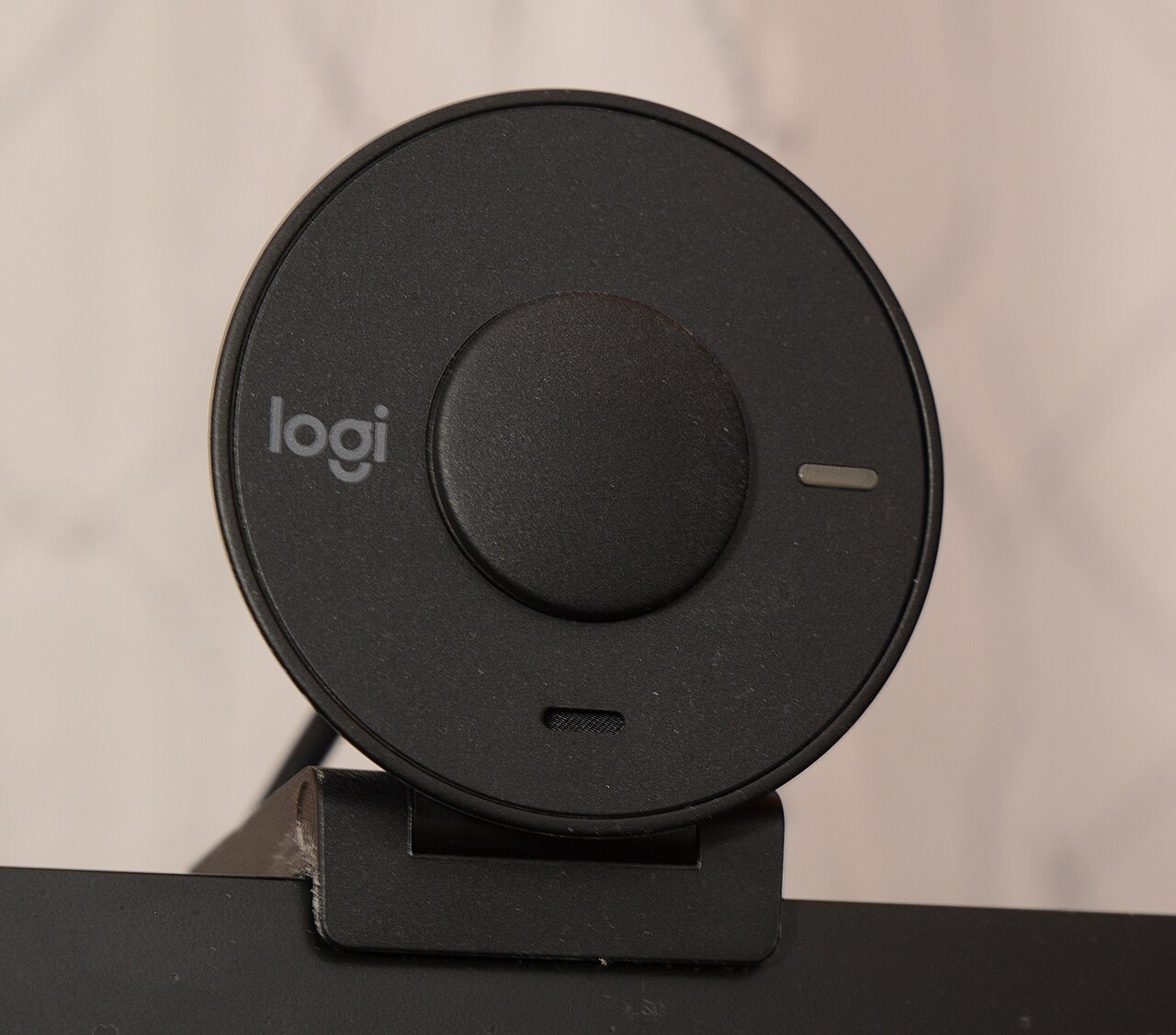 A black webcam mounted on top of a computer monitor